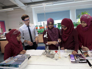 Teacher and pupils at science lesson
