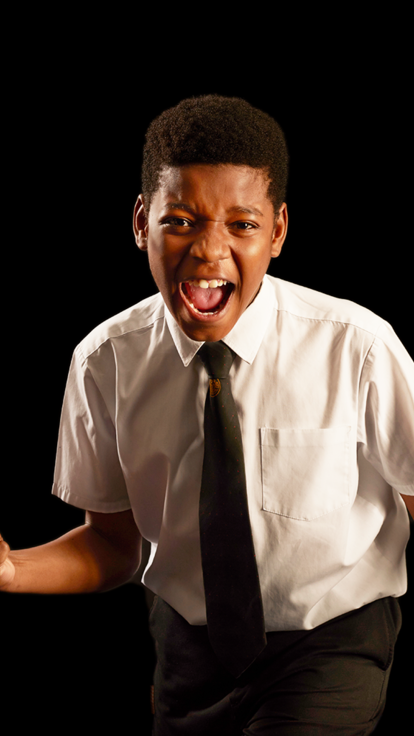 Secondary school pupil boy pumps fists in excitement