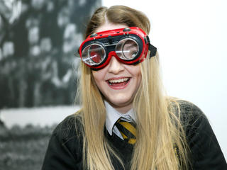 Girl at STEM fair wearing goggles