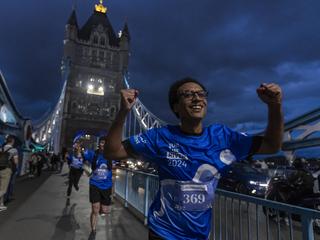 Run the River 2024 Runner running and smiling on Tower Bridge