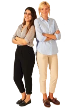 Two teachers standing back to back and smiling to the camera.