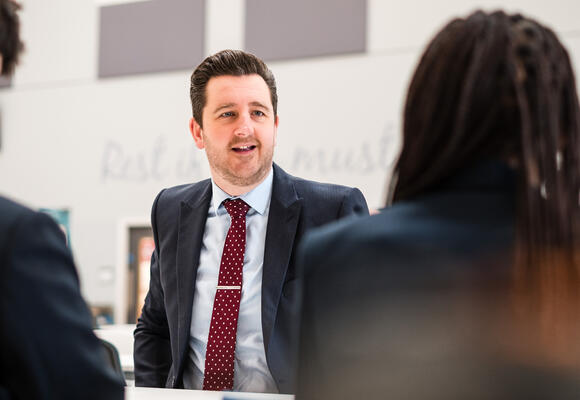 Image of Simon Renshaw looking towards an audience