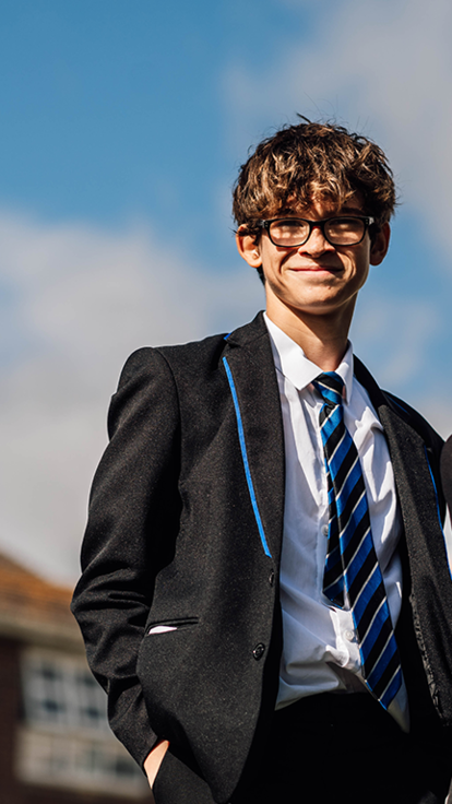 Two students smiling with blue sky background 