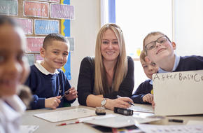 Female teacher with her students smiling at camera